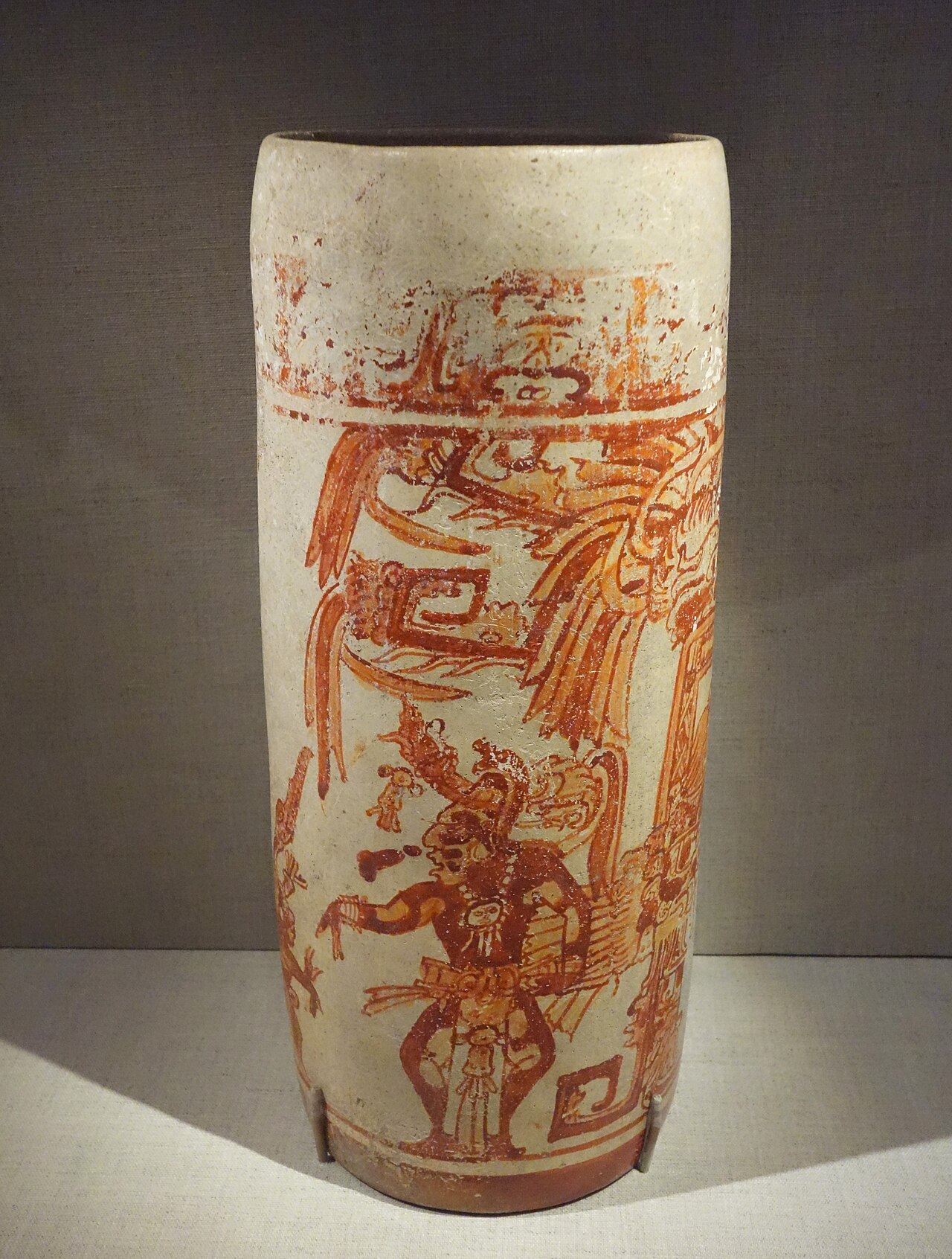 Painted Maya cylinder vase showing the dancing Maize God with an elaborate headdress
